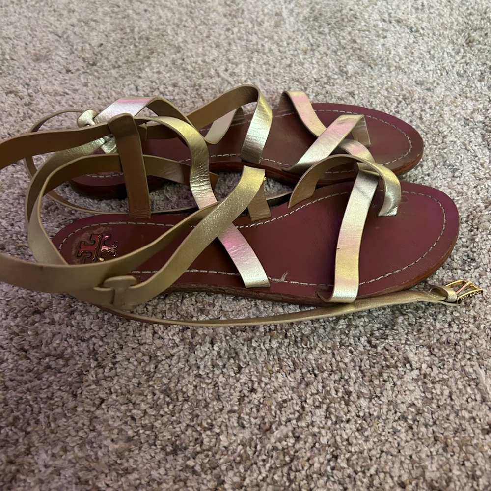 Tory Burch Brown sandals with gold straps.